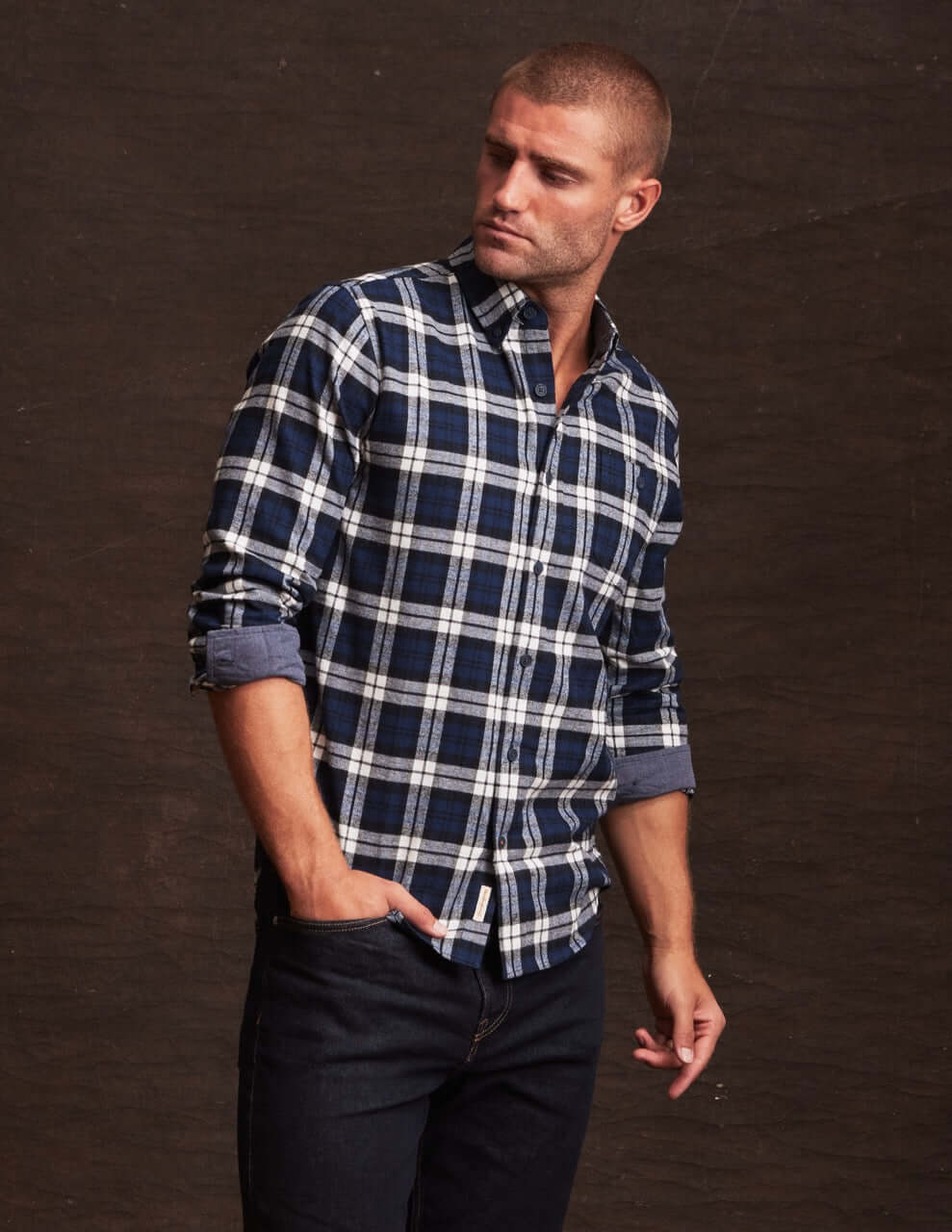 Man wearing a long sleeve blue plaid flannel shirt, showcasing rugged style and soft cotton blend fabric.