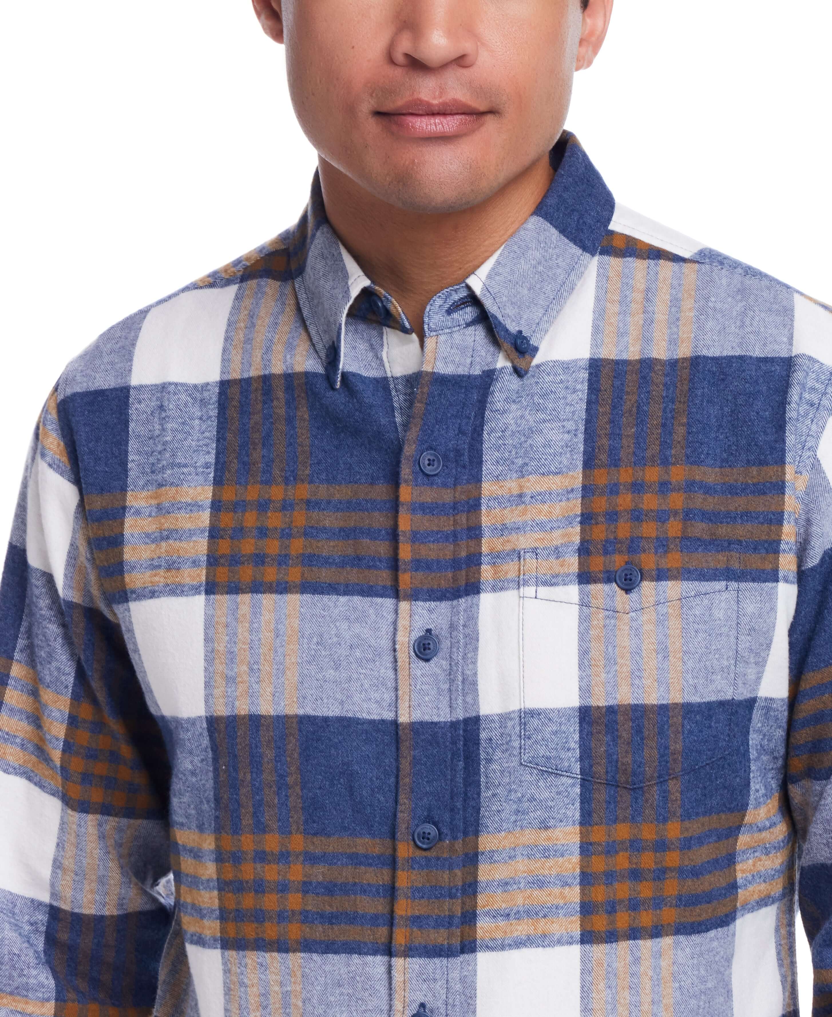 Man wearing a blue plaid long sleeve brushed flannel shirt with button-down collar and breast pocket.