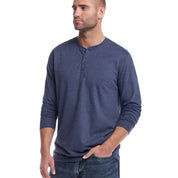 Man wearing a long sleeve brushed jersey henley in maritime blue, showcasing its soft and breathable fabric.