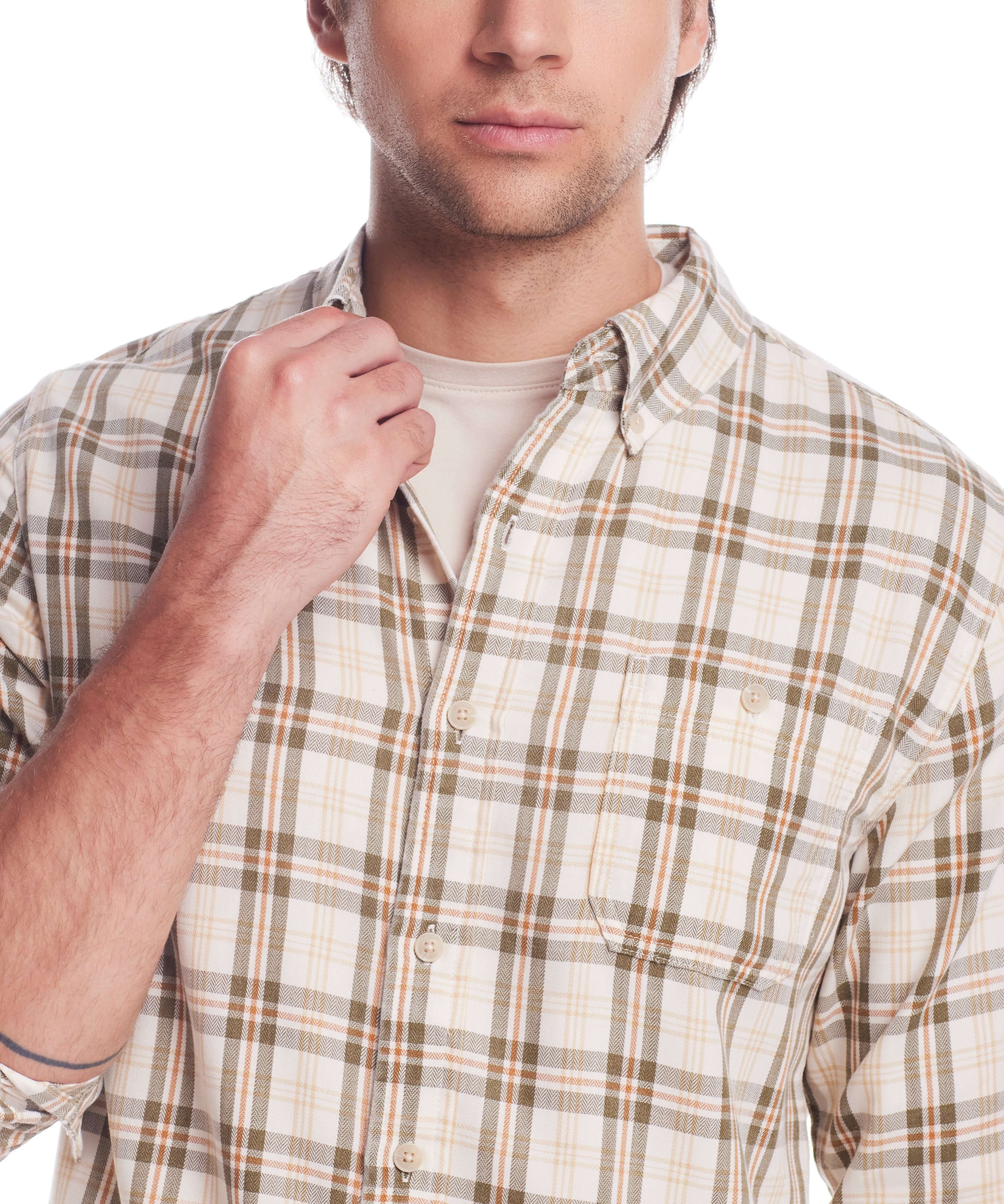 Man wearing a long sleeve burnout flannel shirt in seed pearl, featuring plaid pattern and button cuffs.