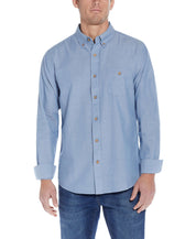 Long Sleeve Chambray Shirt In Chambray Blue displayed on a model, featuring a button down collar and chest pocket.