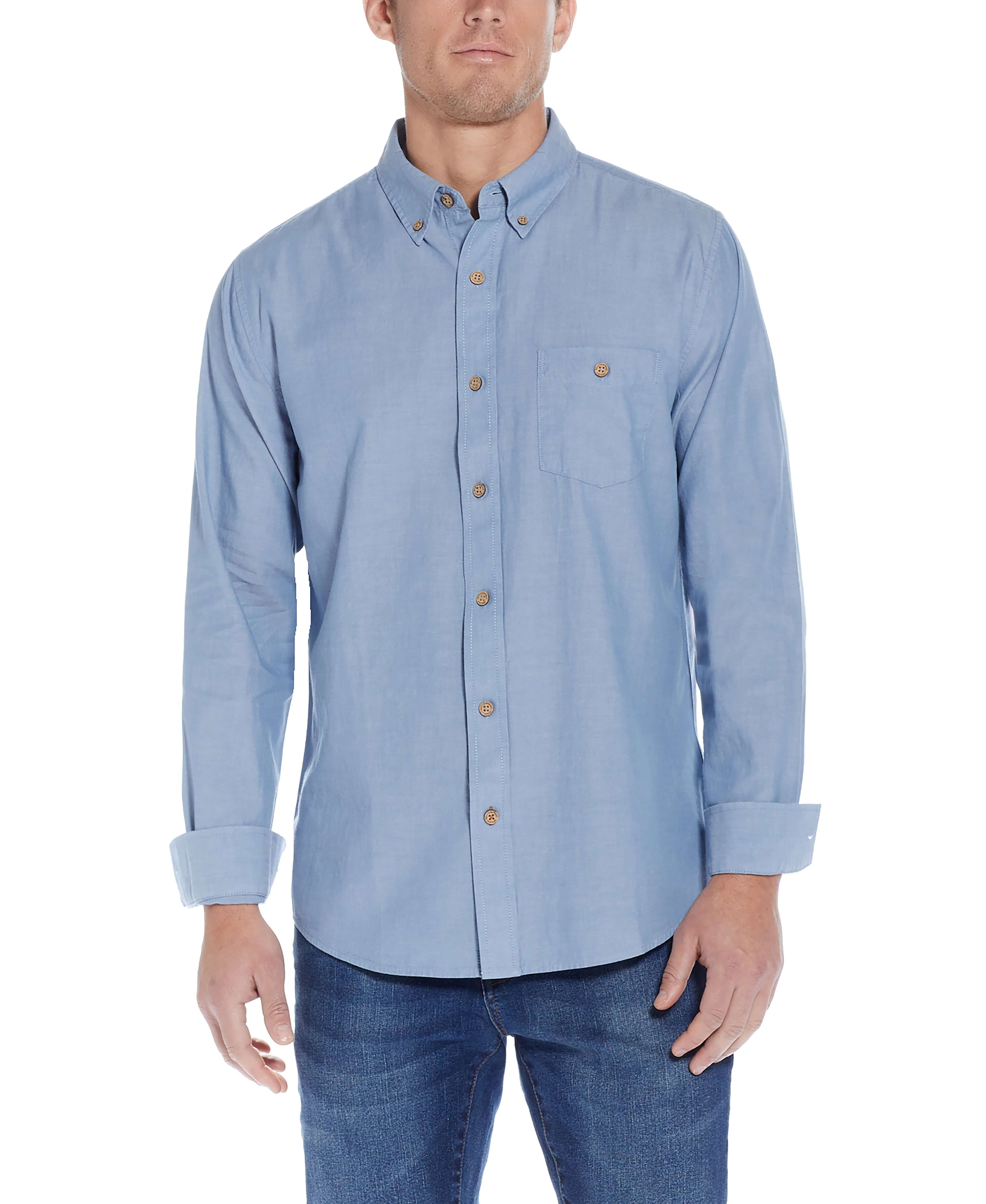 Long Sleeve Chambray Shirt In Chambray Blue displayed on a model, featuring a button down collar and chest pocket.