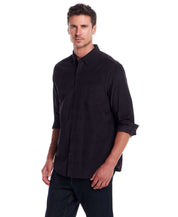Man wearing a Long Sleeve Pebble Corduroy Shirt in Forged Iron, featuring a button-down collar and single chest pocket.