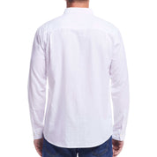 Back view of a man wearing a long sleeve solid cotton twill shirt in white, showcasing its classic design and comfort.