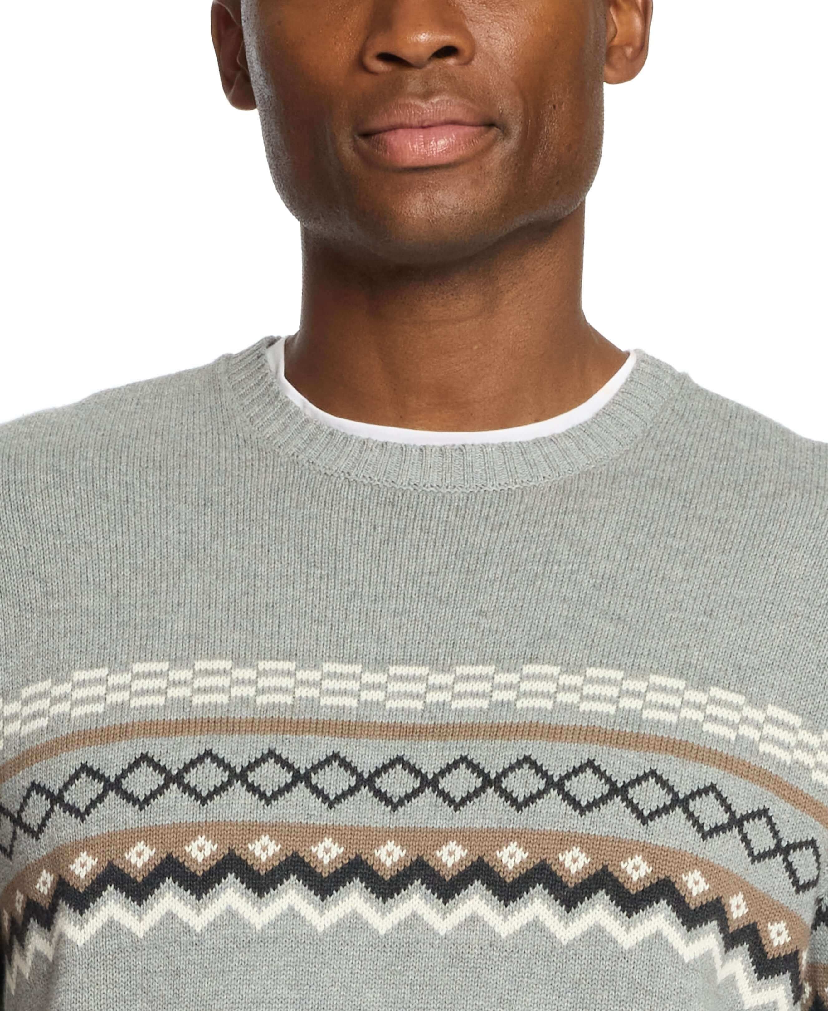 Close-up of a man wearing a Nordic crewneck sweater in pale grey with classic design details.