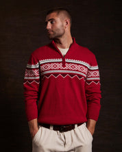 Model wearing Nordic Quarter Zip Sweater in Tartan Red, showcasing festive design and cozy cotton fabric.