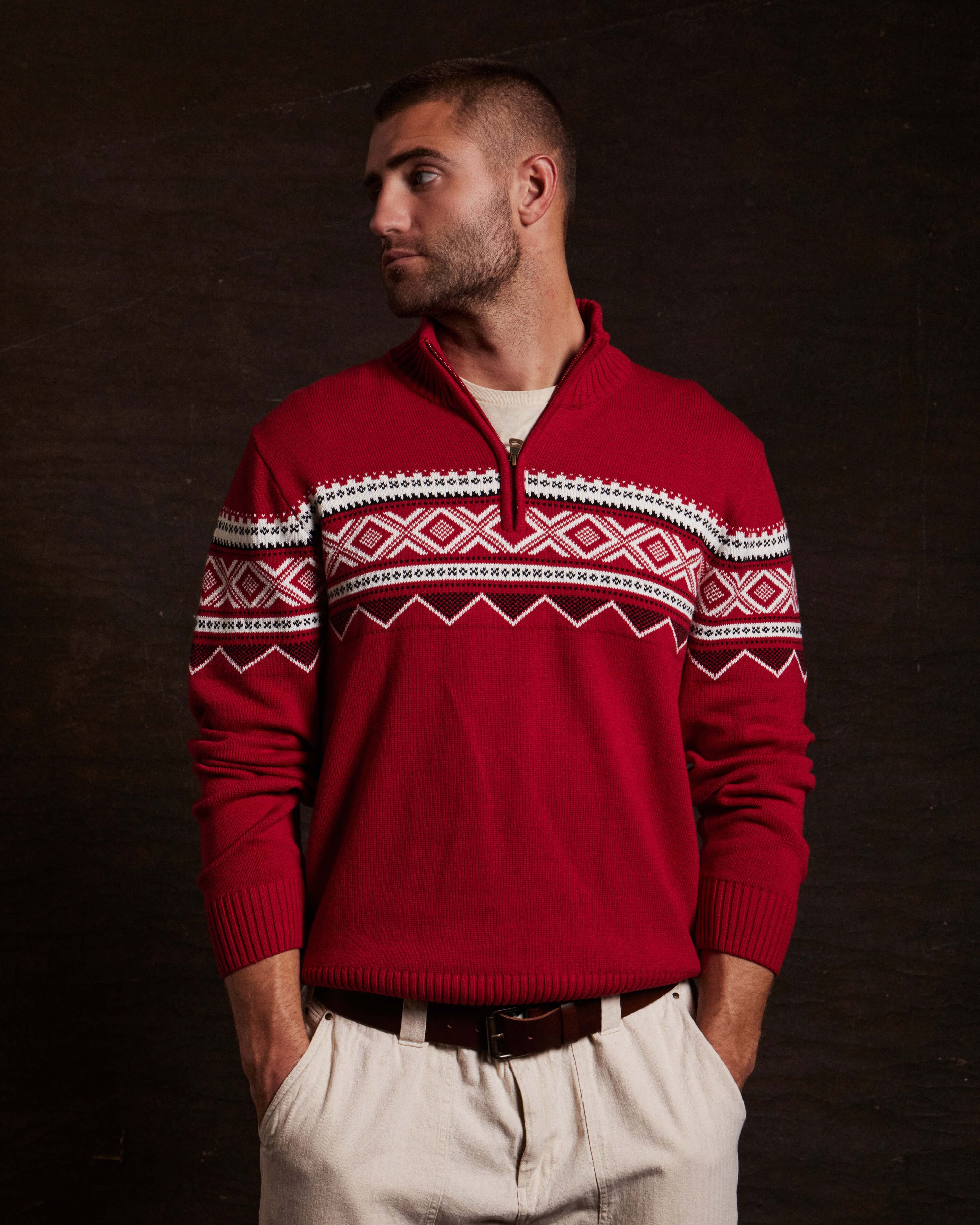 Model wearing Nordic Quarter Zip Sweater in Tartan Red, showcasing festive design and cozy cotton fabric.