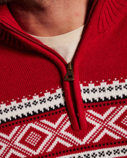 Close-up of Nordic Quarter Zip Sweater in Tartan Red, featuring a unique patterned chest and quarter zip detail.