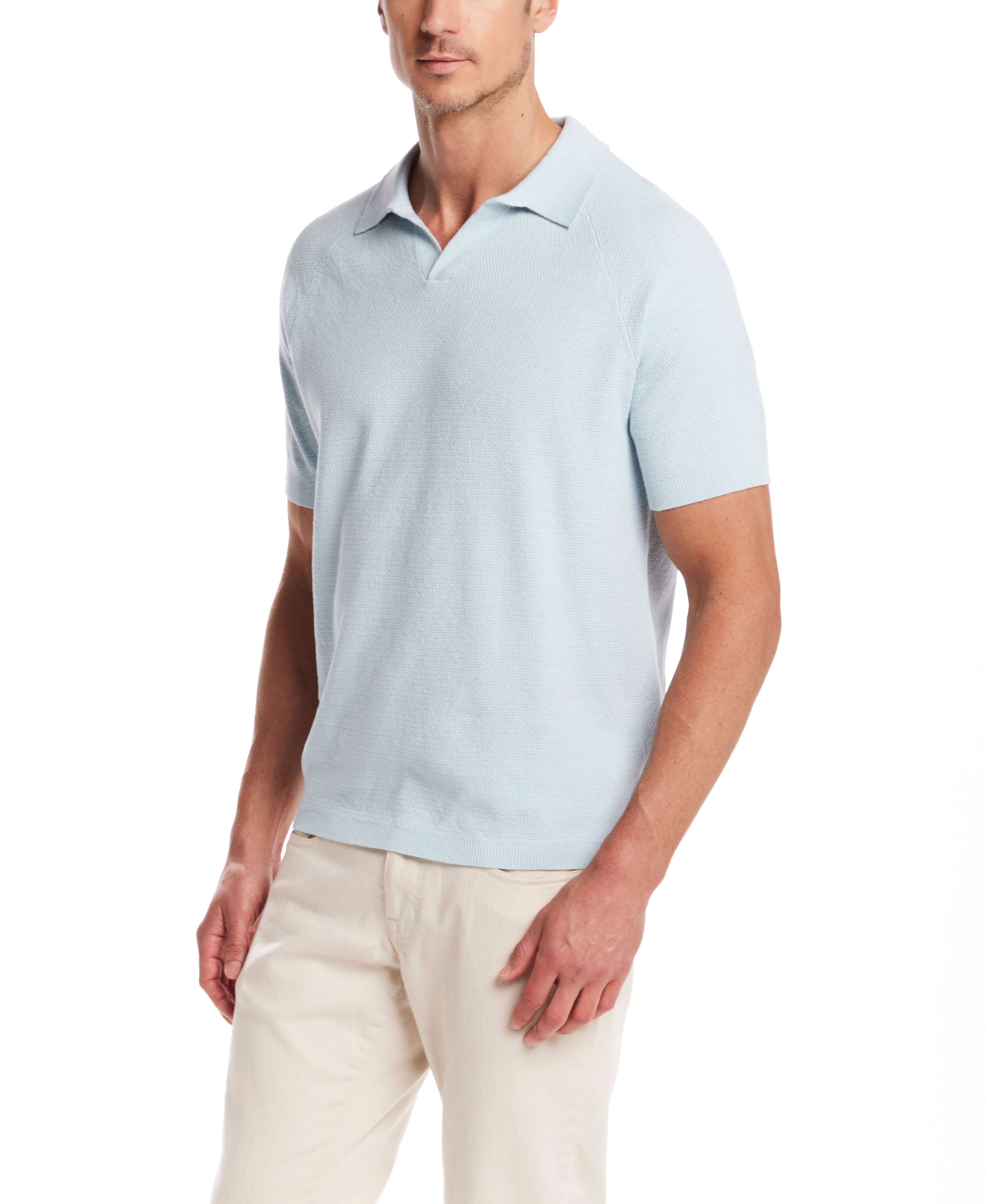 Stylish man wearing an aqua twist open collar polo sweater, showcasing a relaxed fit and modern design.