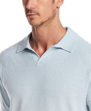 Close-up of a man wearing an aqua twist open collar polo sweater, showcasing its lightweight knit and classic style.