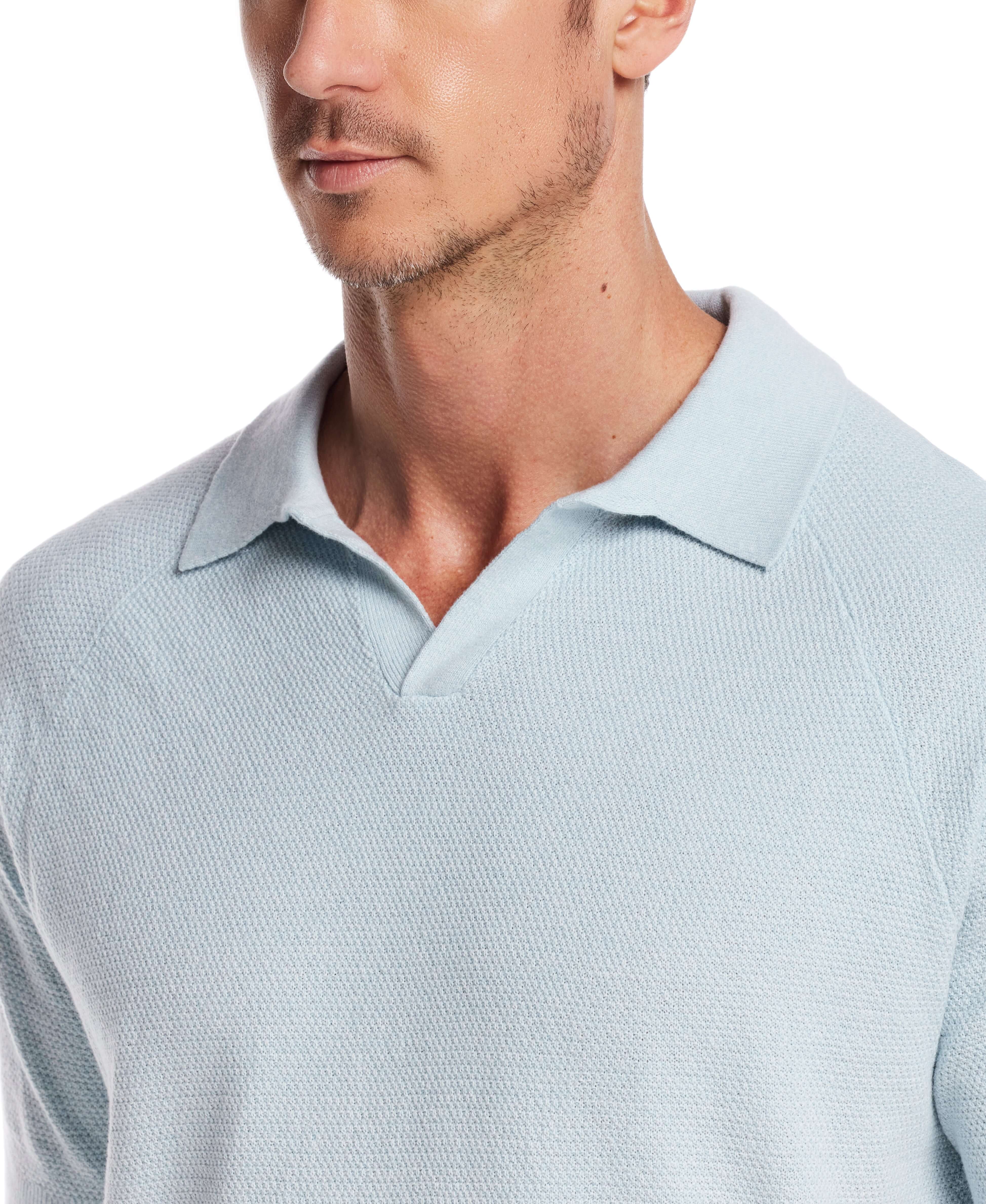 Close-up of a man wearing an aqua twist open collar polo sweater, showcasing its lightweight knit and classic style.