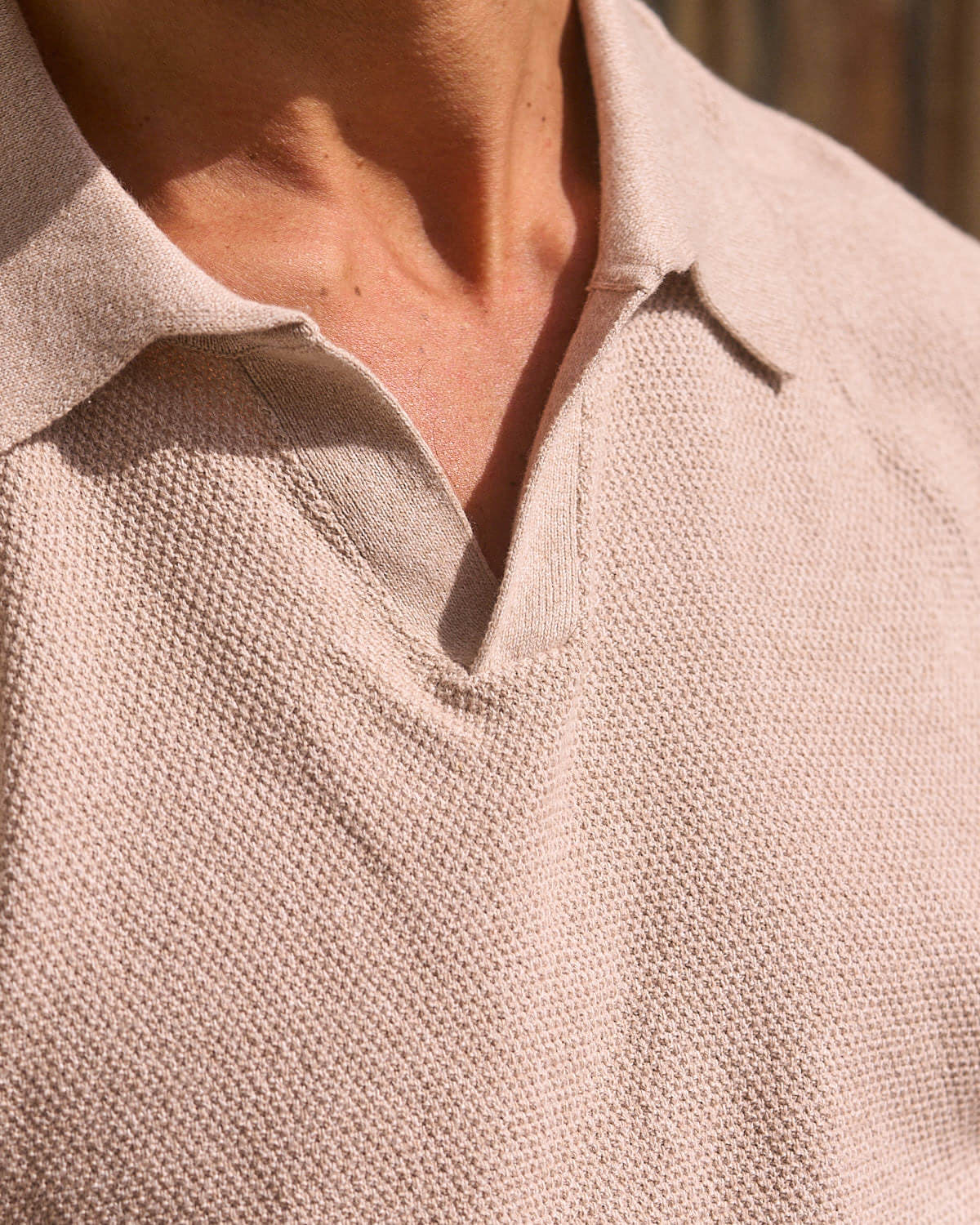 Close-up of the Open Collar Polo Sweater in Oat Twist, showcasing its textured knit and collared neckline.