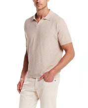 Man wearing an Open Collar Polo Sweater in Oat Twist, showcasing a stylish and comfortable knit design.