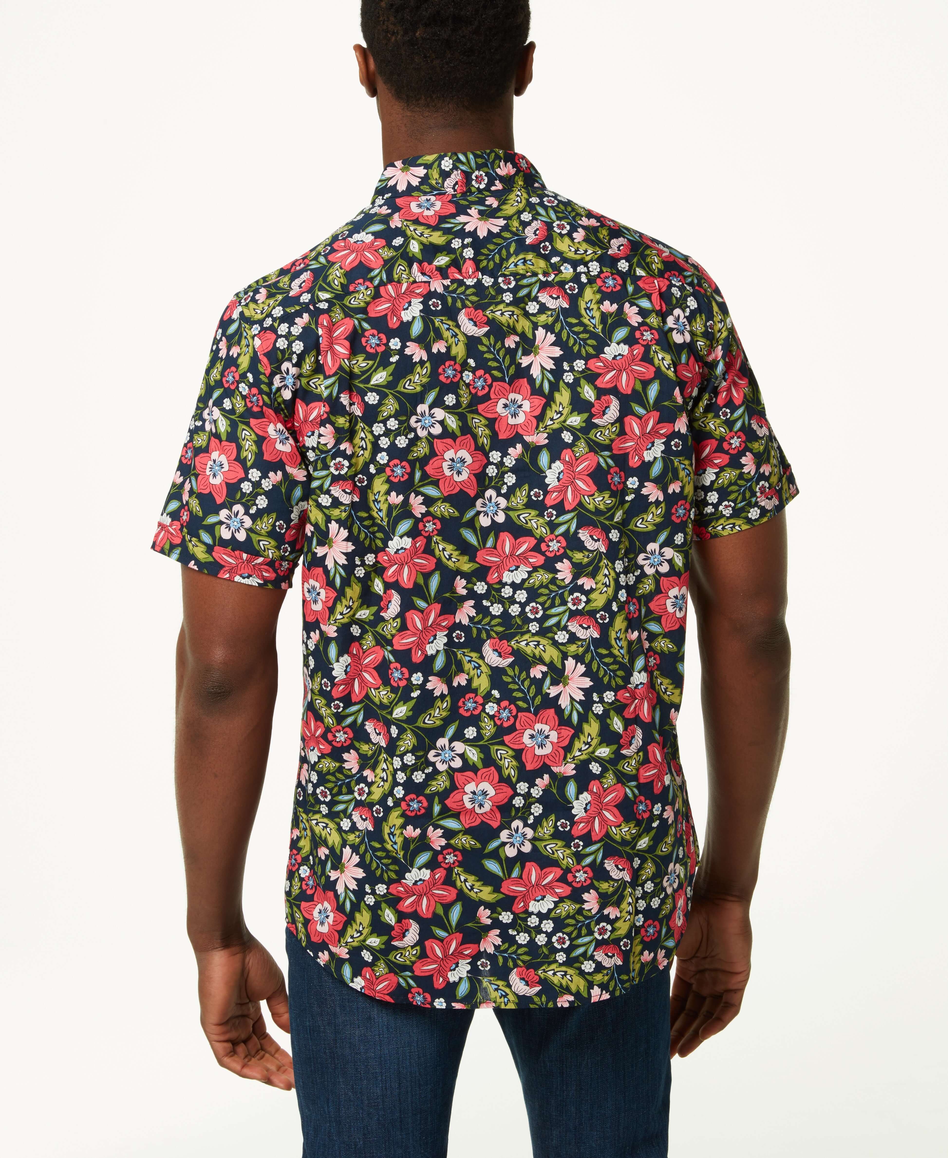 Back view of a man wearing a Poplin Floral Print In Blue Night shirt with vibrant floral designs.