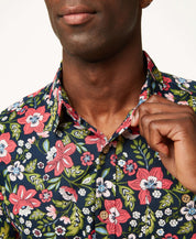 Man wearing a Poplin Floral Print In Blue Night shirt with vibrant floral design and button down collar.