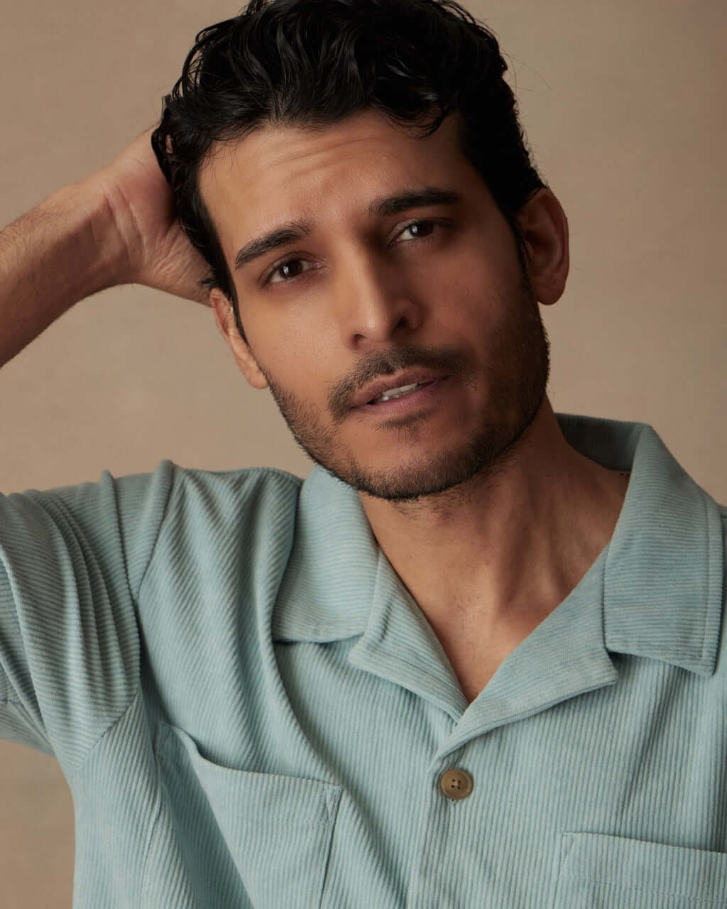 Model wearing a short sleeve teal mist corduroy cabana shirt with a camp collar and double chest pockets.