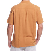 Back view of a man's short sleeve cotton linen Airtex shirt in biscuit color, showcasing classic vacation style and camp collar.