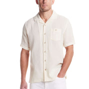 Short sleeve cream cotton linen Airtex shirt with camp collar and button down pocket, perfect for vacation style.