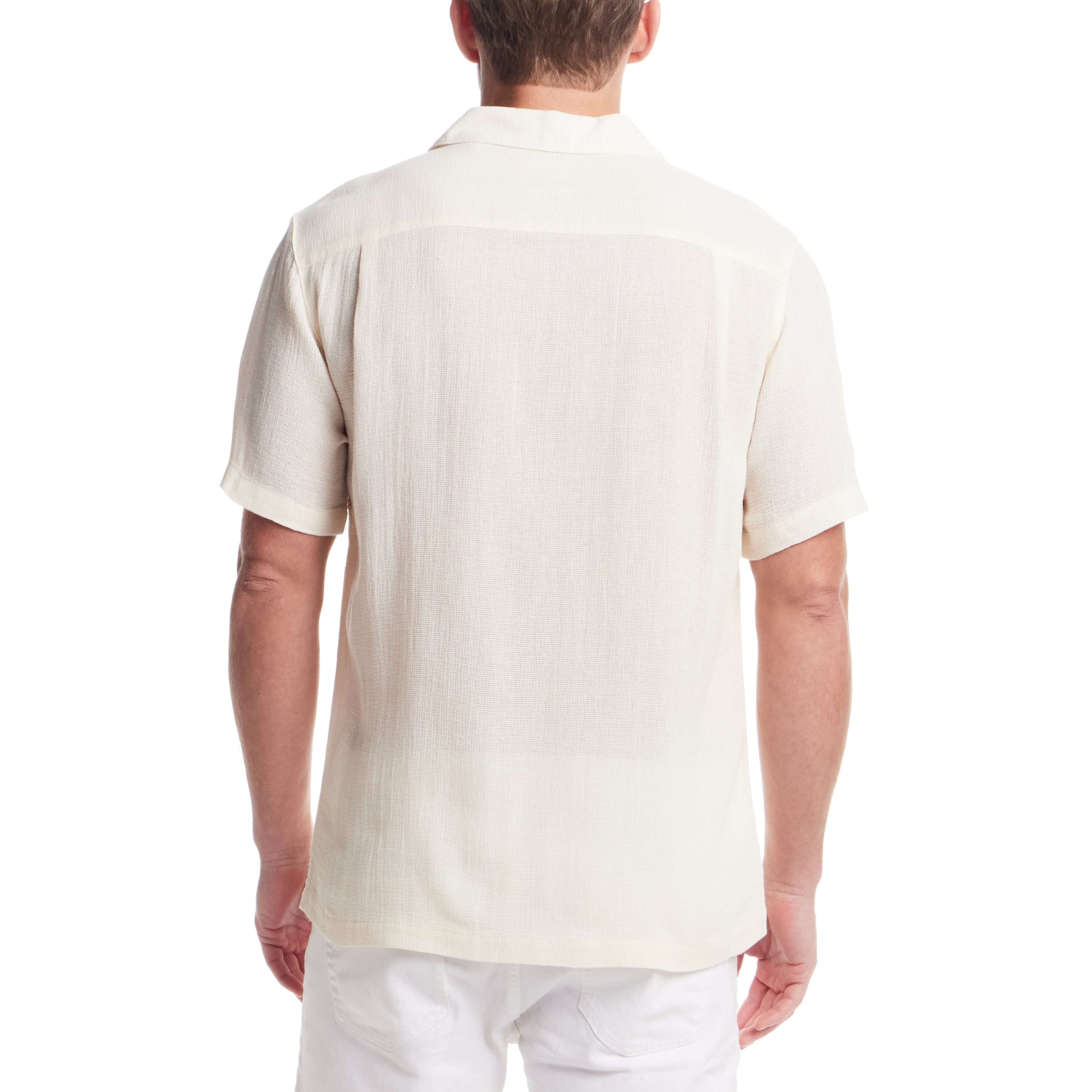 Back view of a man wearing a short sleeve cream Airtex shirt, showcasing its classic vacation style and camp collar.