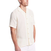 Short sleeve cream Airtex shirt made of cotton and linen, featuring a camp collar and button-down pocket.