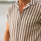 Short sleeve cotton linen stripe shirt in insignia blue with camp collar and button-down chest pocket.