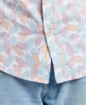 Lavender leaf patterned short sleeve cotton poplin shirt, showcasing classic tailoring and button detail, paired with denim.