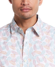 Close-up of a man wearing a lavender leaf patterned short sleeve cotton poplin shirt with a button-down collar.