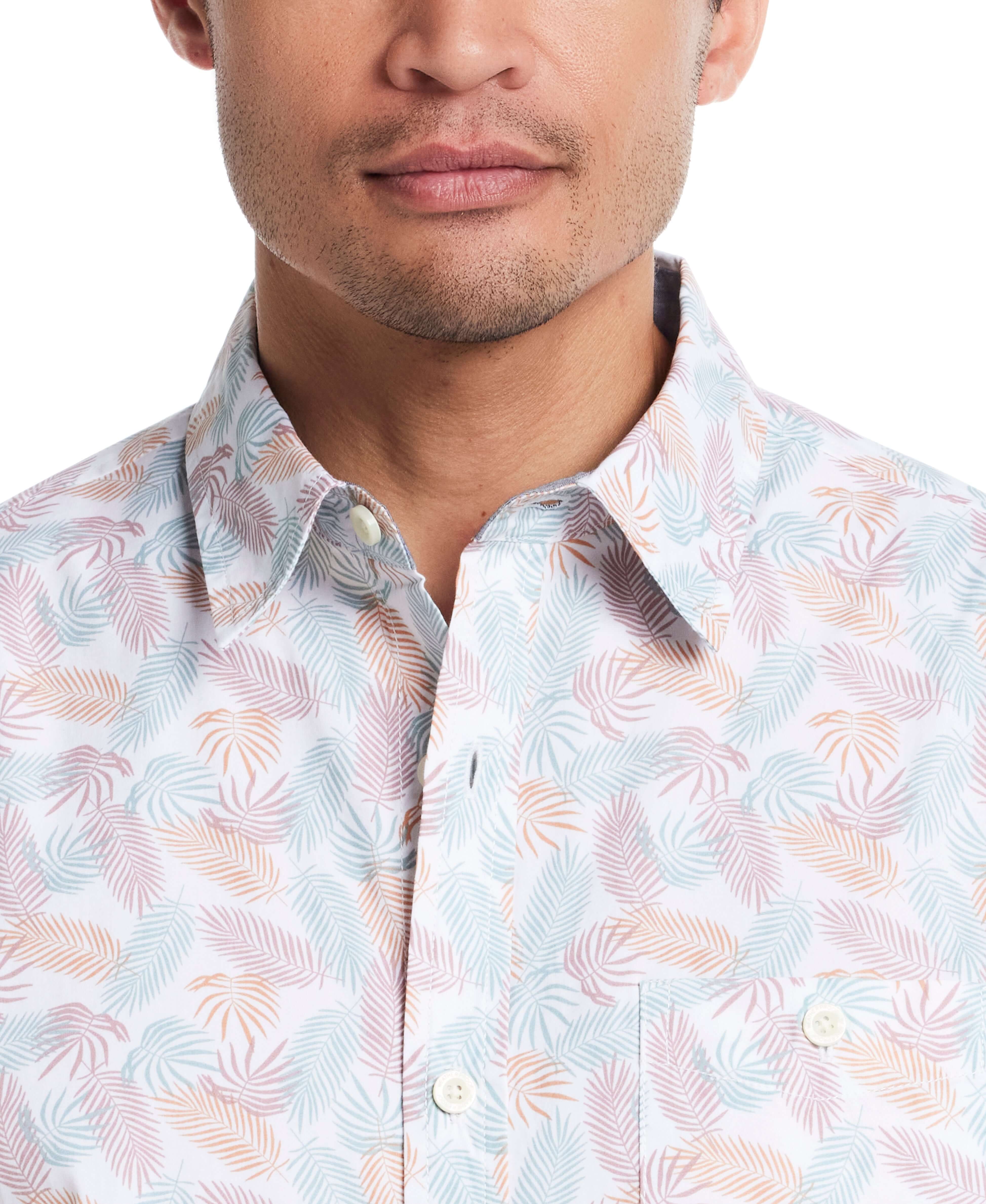 Close-up of a man wearing a lavender leaf patterned short sleeve cotton poplin shirt with a button-down collar.