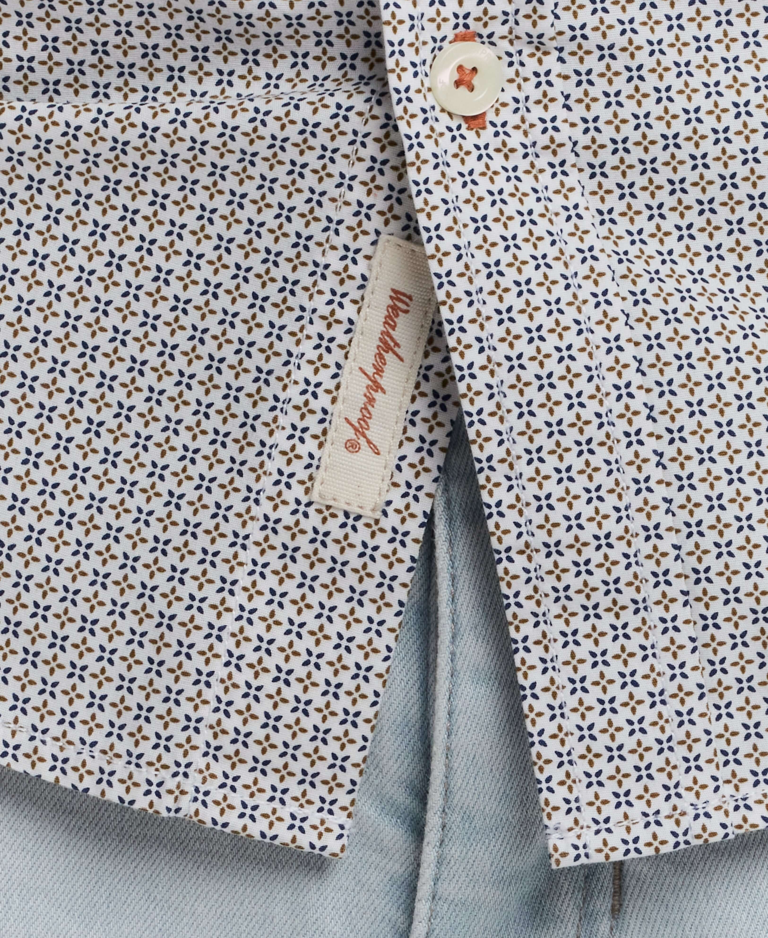 Close-up of a patterned cotton poplin shirt showcasing button detail and label, ideal for classic tailoring and polished style.