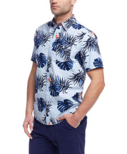 Short sleeve cotton poplin shirt with tropical leaf print in light blue, featuring button down pocket and classic fit.