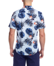 Back view of short sleeve shirt in tropical print featuring blue leaves and coral accents, showcasing a classic fit.