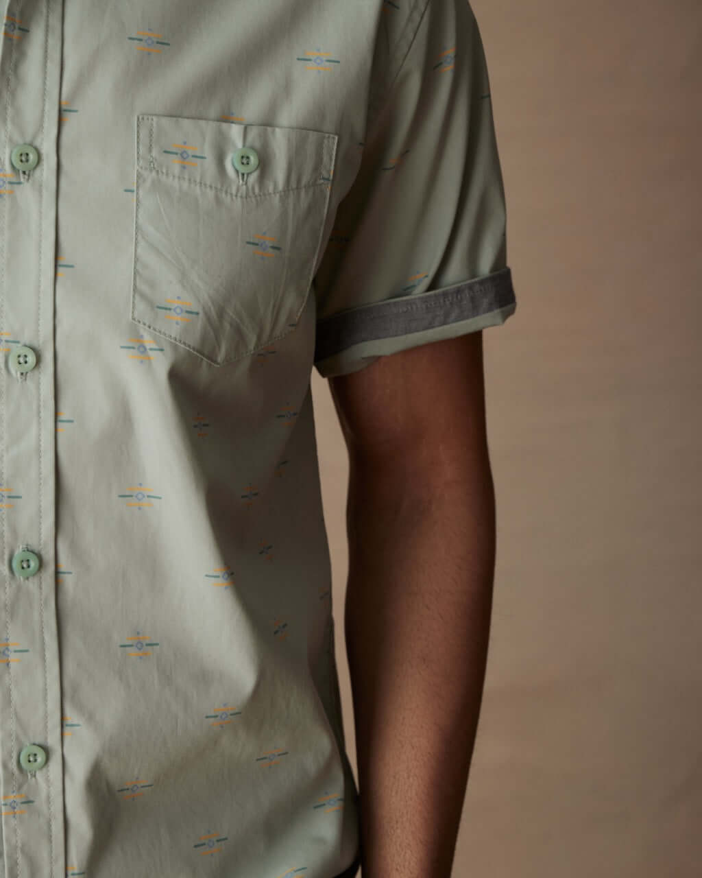 Close-up of a teal mist short sleeve cotton poplin shirt with a button down pocket and cuffed sleeve.
