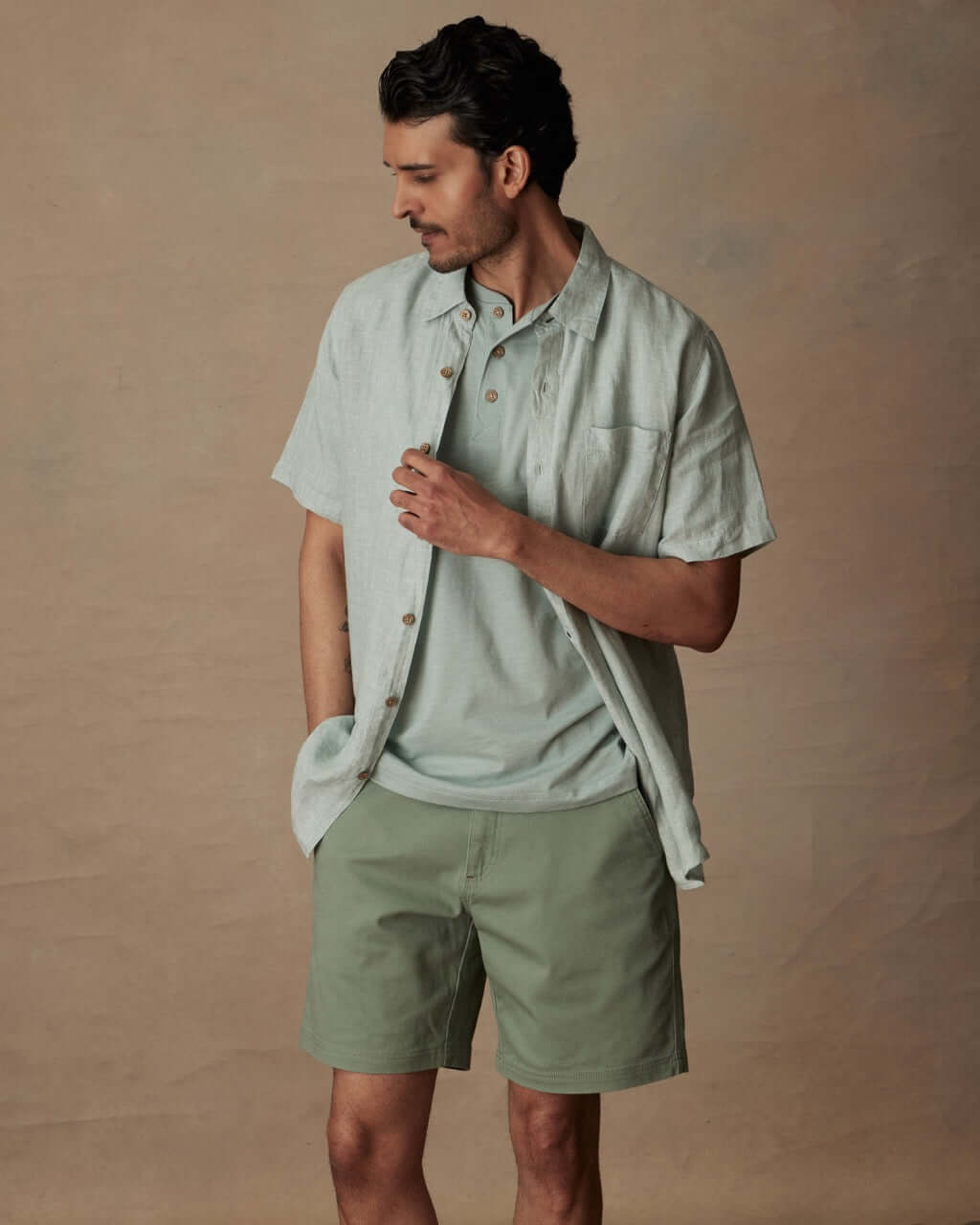 Model wearing a Short Sleeve Cotton Poplin Shirt in Teal Mist, showcasing its classic fit and button-down pocket details.