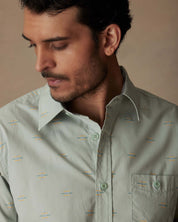 Model wearing a short sleeve teal mist cotton poplin shirt with a button-down pocket and spread collar.