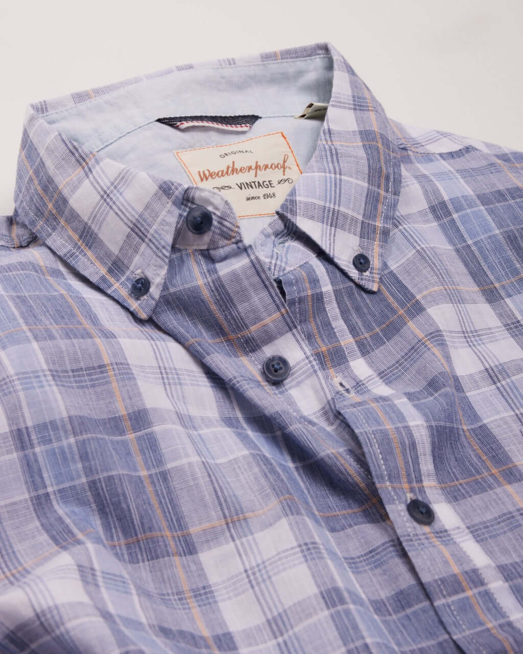 Short Sleeve End-On-End Plaid In Kentucky Blue shirt featuring a relaxed fit, short sleeves, and button details.