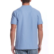 Back view of a man wearing a short sleeve fjord blue honeycomb pique polo shirt, showing ribbed collar and cuffs.