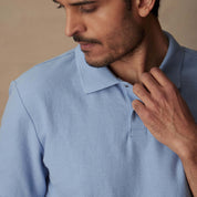 Close-up of a man wearing a Short Sleeve Honeycomb Pique Polo Shirt in Fjord Blue, featuring a classic ribbed collar.