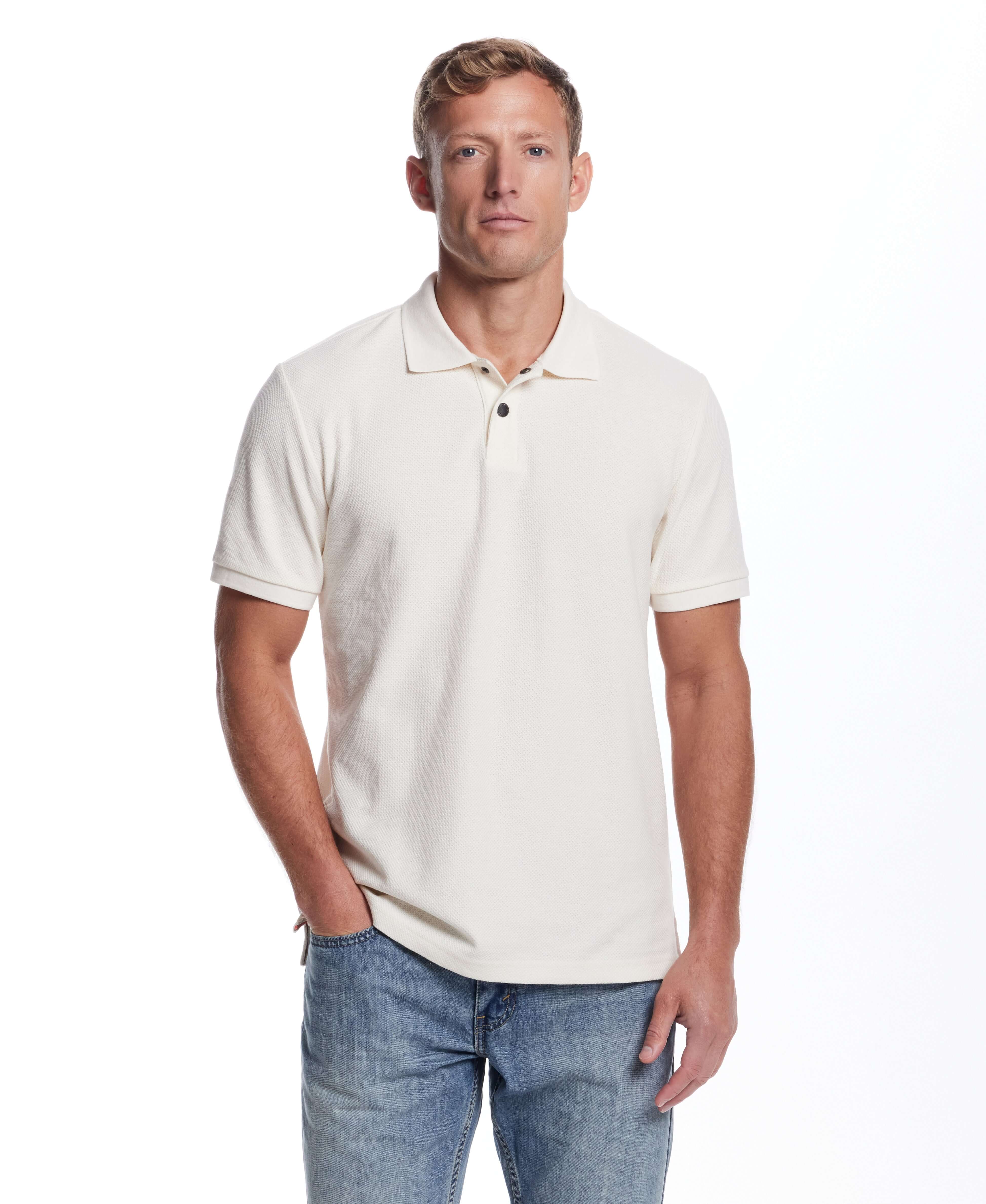 Men's short sleeve ivory honeycomb pique polo shirt with ribbed collar and snap placket, styled casually.