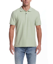 Light green short sleeve honeycomb pique polo shirt on male model, showcasing classic fit and ribbed collar.