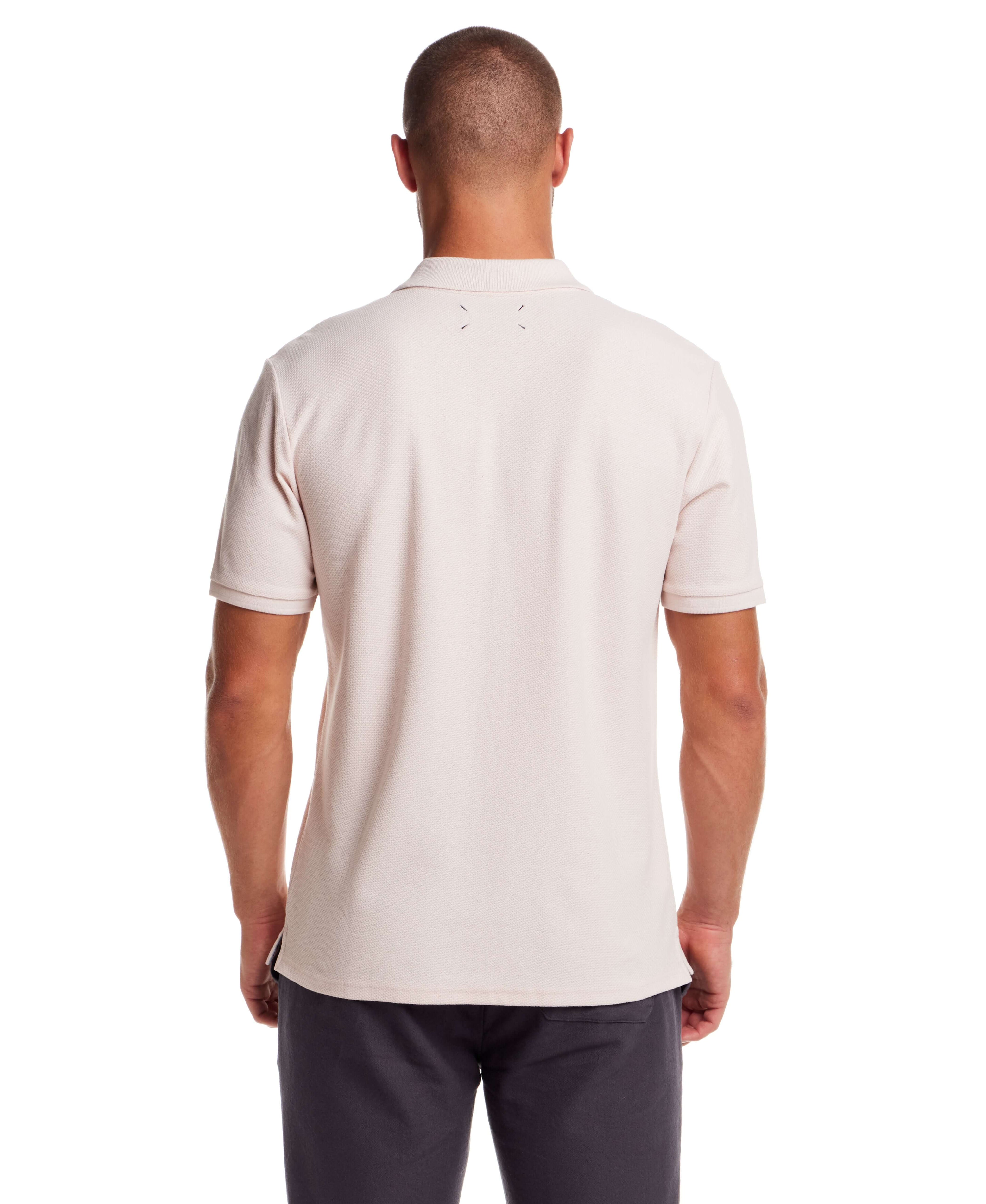 Back view of a regular-fit short sleeve honeycomb pique polo shirt in pink, showcasing ribbed collar and cuffs.