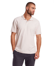 Man in short sleeve pink honeycomb pique polo shirt with ribbed collar and cuffs, modeling classic fit.