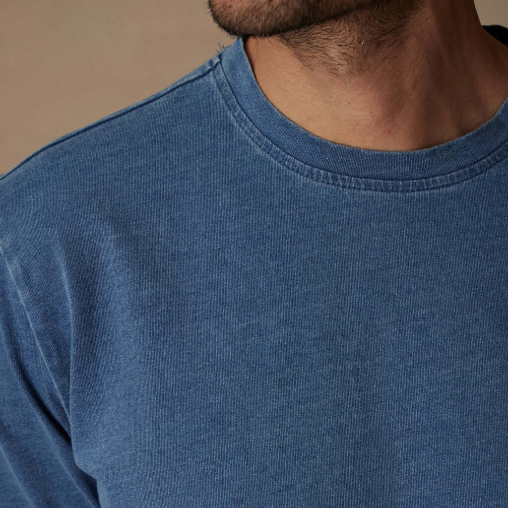 Model wearing a close-up of a soft touch short sleeve indigo crew t-shirt for layering in vintage style.