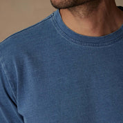 Model wearing a close-up of a soft touch short sleeve indigo crew t-shirt for layering in vintage style.
