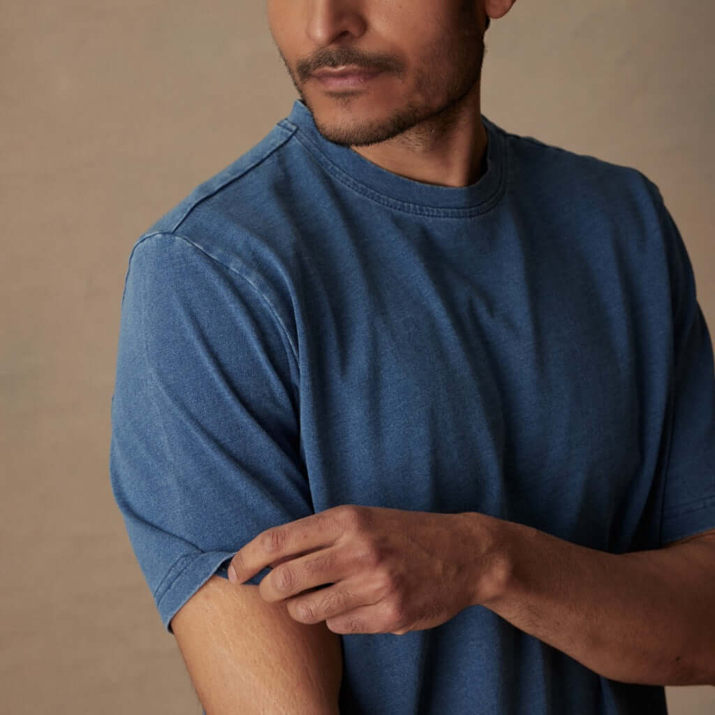 Model wearing short sleeve indigo crew t-shirt, showcasing its soft texture and classic fit against a neutral background.
