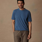 Model wearing short sleeve indigo crew t-shirt, showcasing its soft slub cotton texture and classic fit.