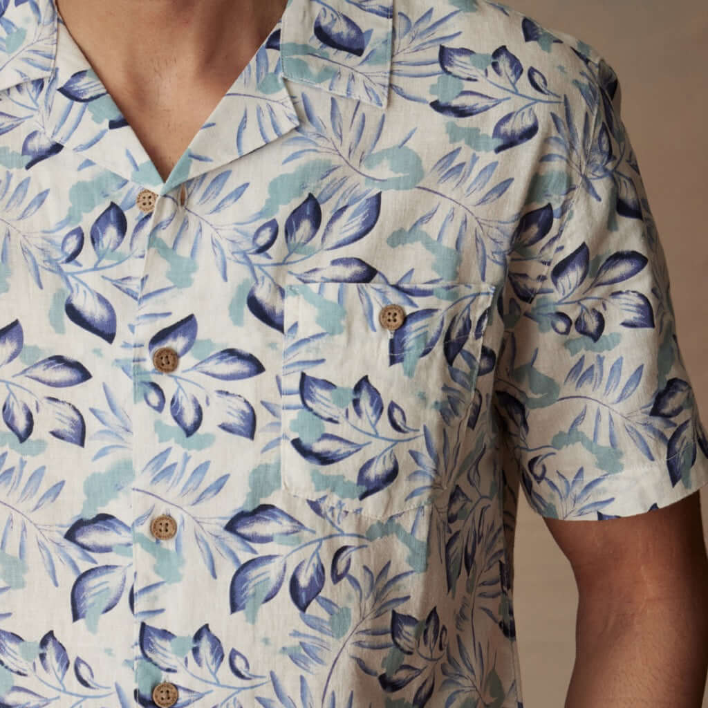 Short sleeve linen cotton camp shirt in Fjord Blue with botanical print and camp collar detail.