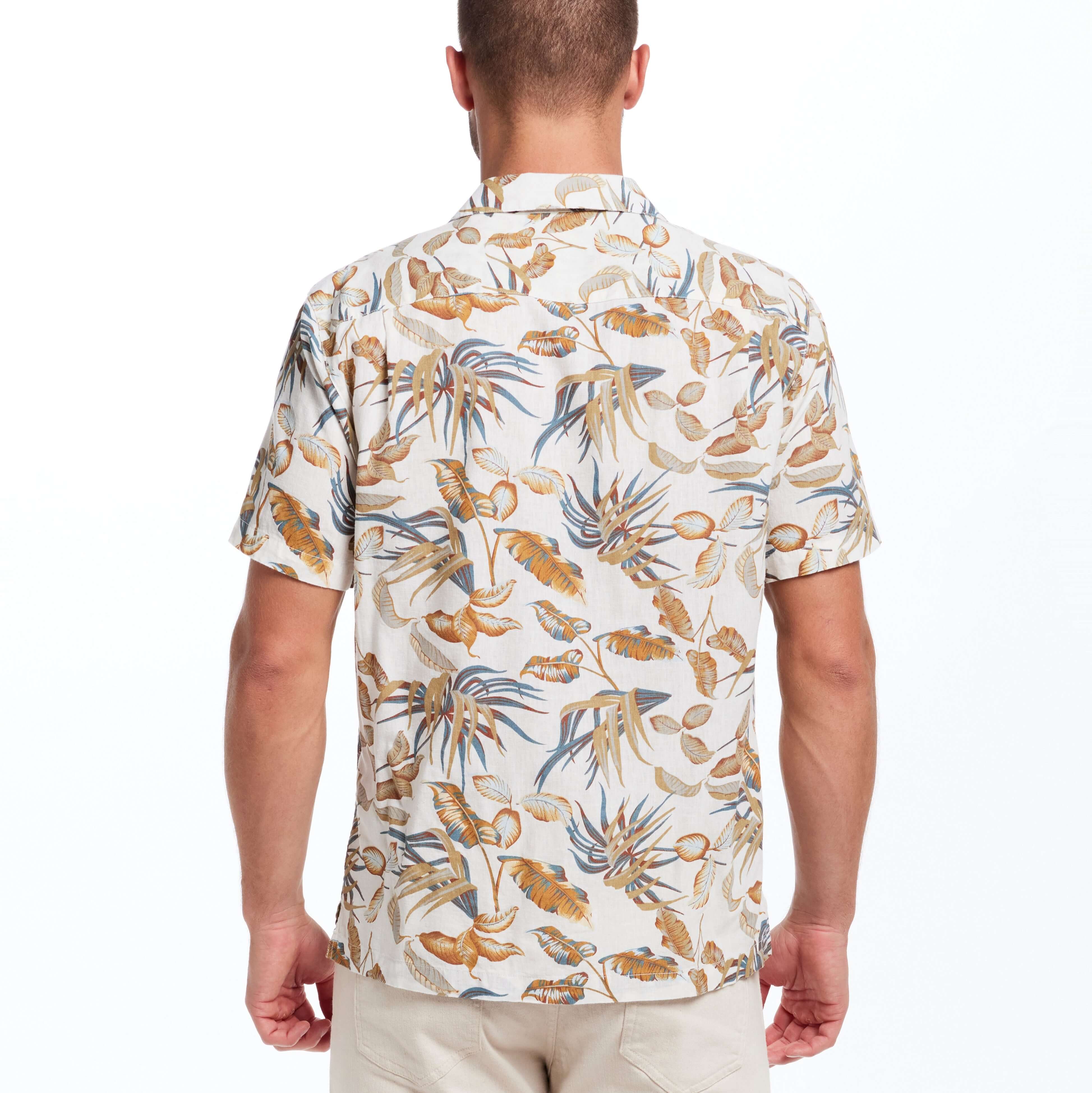 Model wearing a short sleeve linen cotton camp shirt in a bold print with a camp collar and square hem.