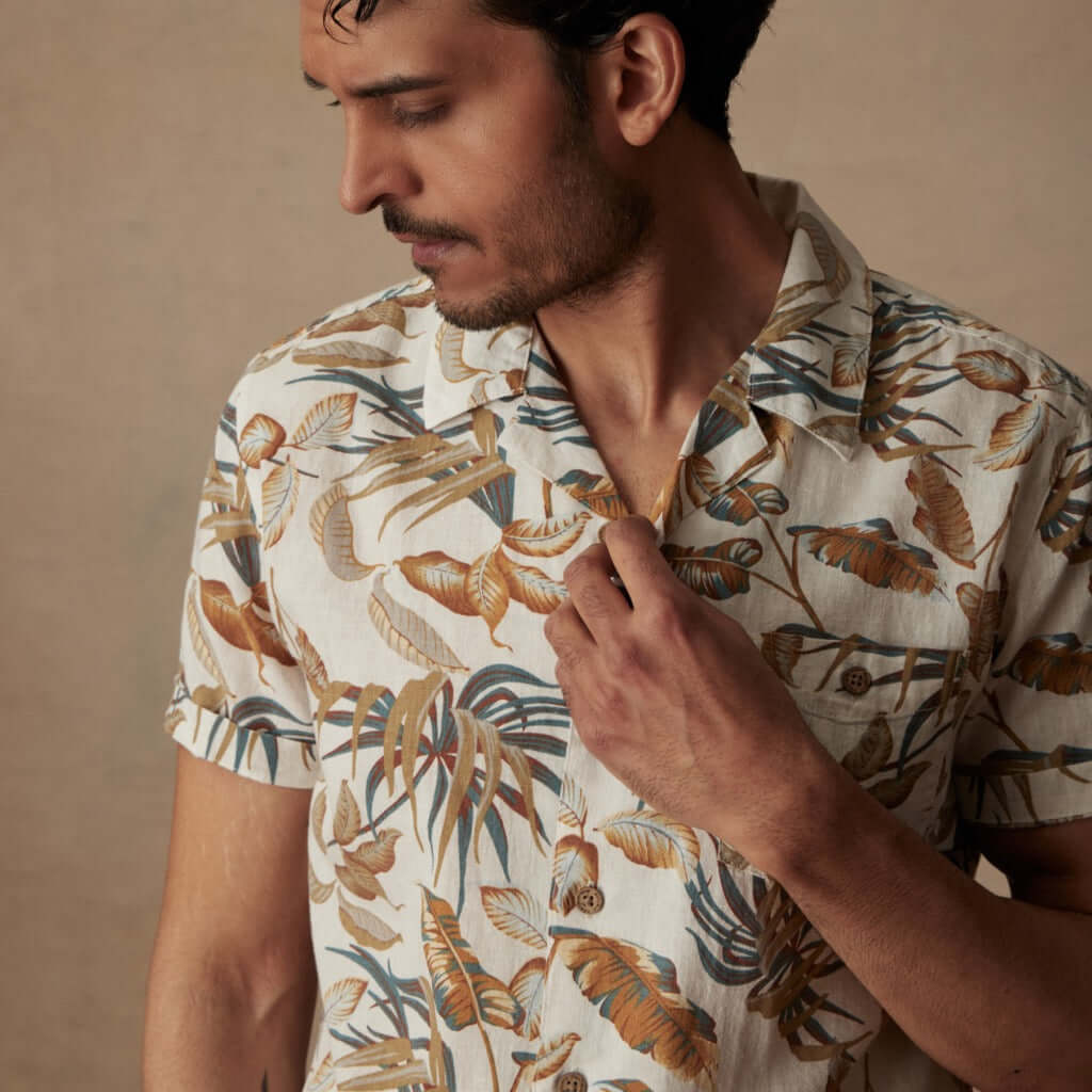 Short sleeve linen cotton camp shirt in Sugar Almond on a model, featuring a vibrant floral print and camp collar.