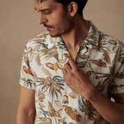 Short sleeve linen cotton camp shirt in Sugar Almond on a model, featuring a vibrant floral print and camp collar.