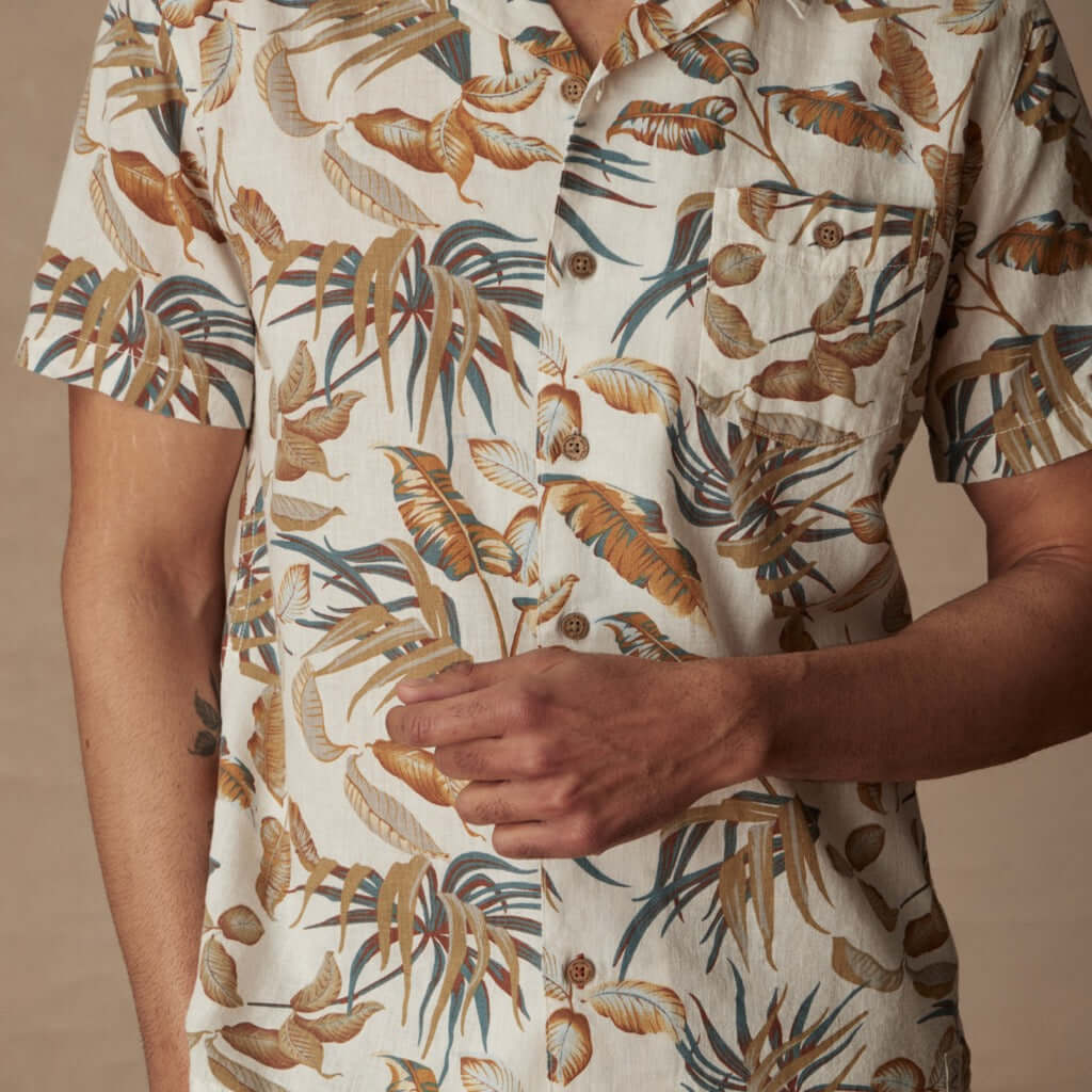 Short sleeve linen cotton camp shirt in Sugar Almond featuring bold tropical print and camp collar design.
